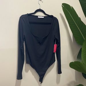 Black long sleeve ribbed bodysuit with snap crotch and wire v-neck detail